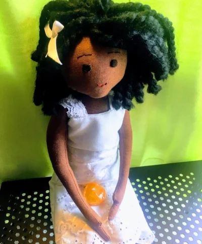 This custom doll by Jacqueline Bryant Campbell wears a dress made from the author’s daughter’s baptismal gown.