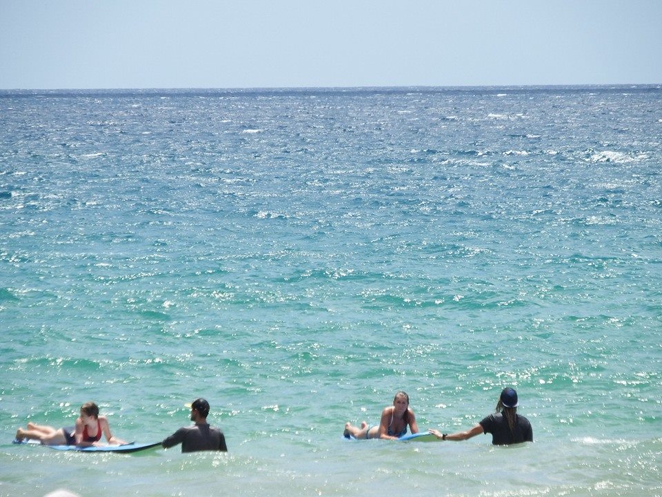 Justo and Jeremy await a big wave for the first-time surfers to ride