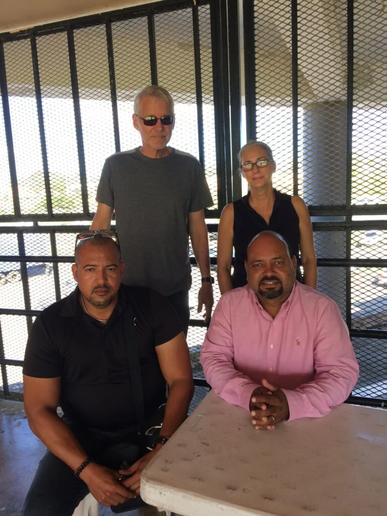 The Rio Grande mayor Angel "Bori" González and police commissioner Sr. Escobar are seated in their emergency office. In this photo Renée and I are just starting the interview.