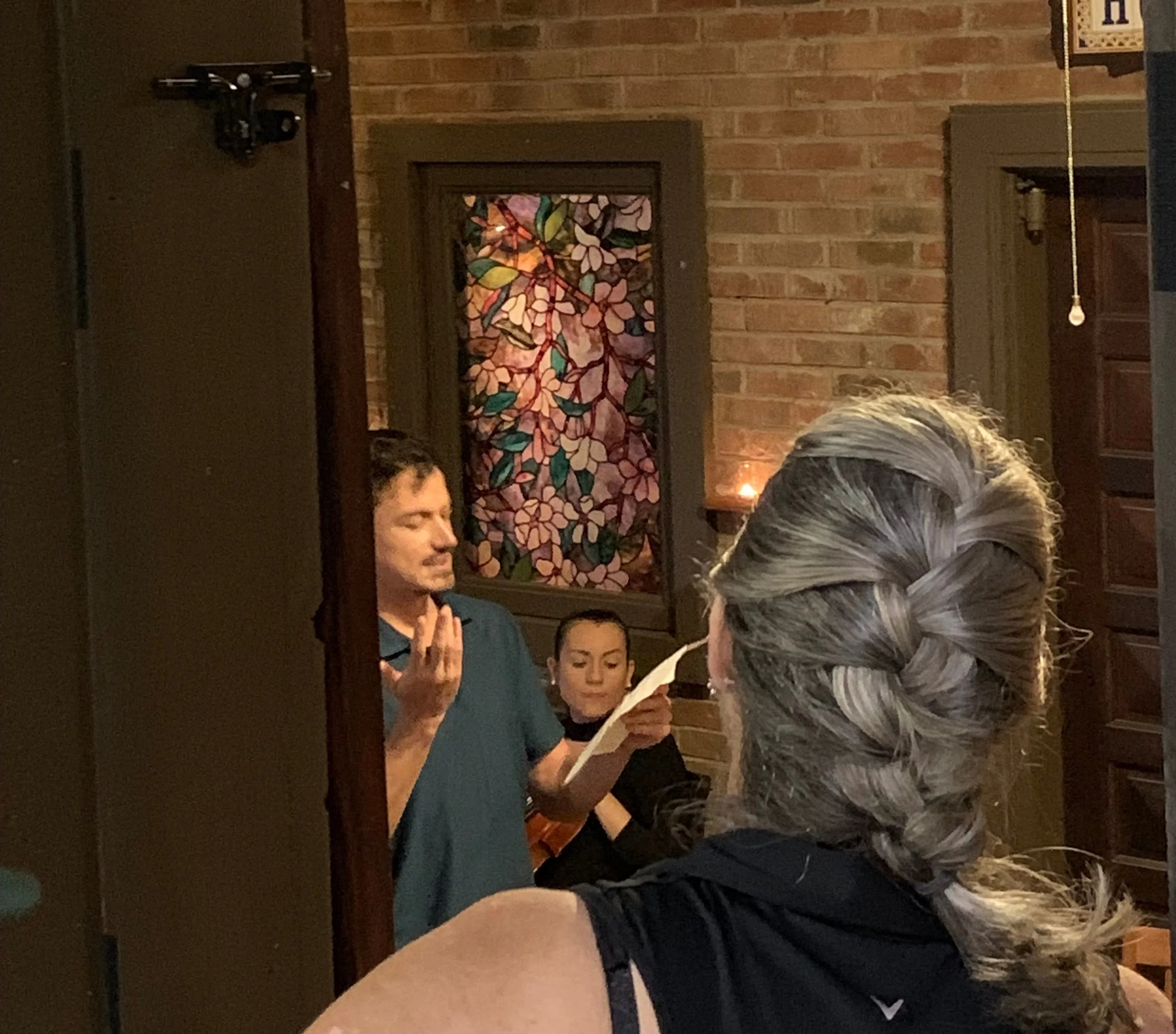 Robert Egan reads his poem while Renée listens from the kitchen.