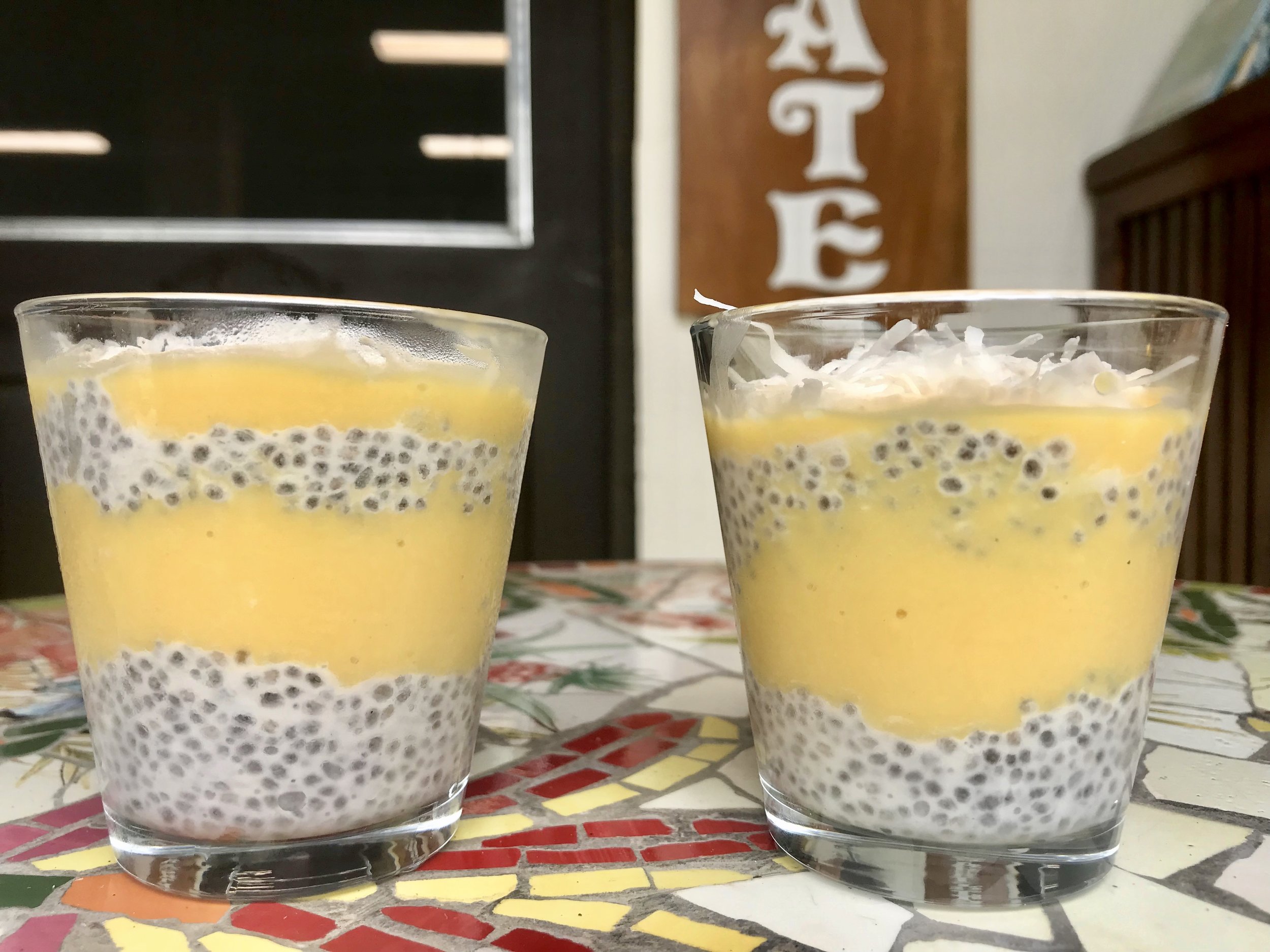 Chia seed pudding layered with mango puree and coconut flakes