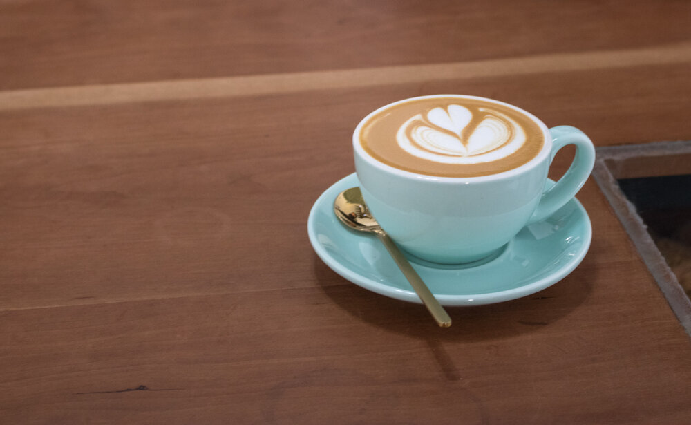  A beautiful cappuccino served in a light blue cup  