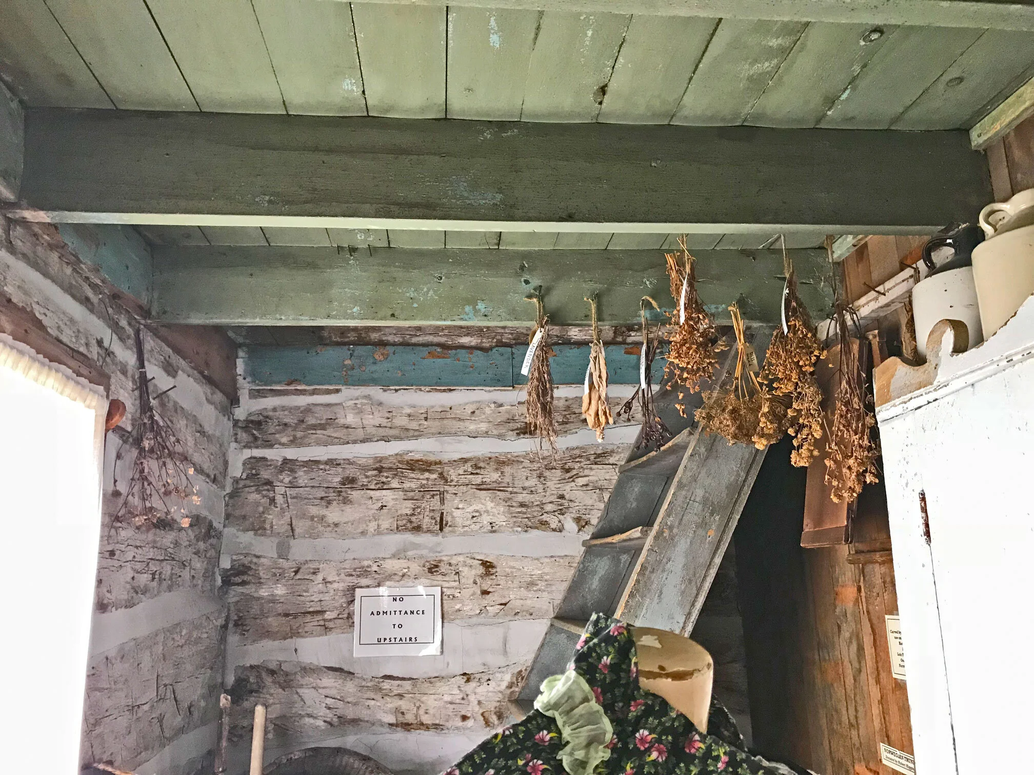 One of the two rooms off the main kitchen/living room. Note that this room contains the staircase to the 2nd story, which was also likely used as a bedroom space. This room is often a pantry room or storage room that did not often contain a stove du…