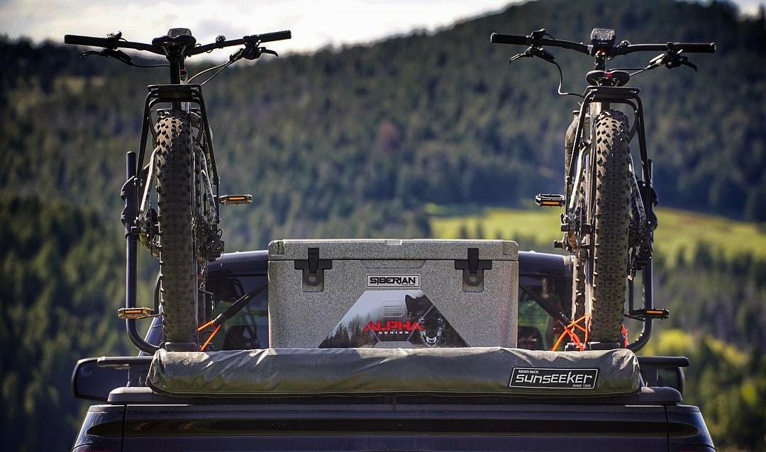 Lifestyle Photo Alpha Pro Series Coolers in the back of a truck with cross country bicycles