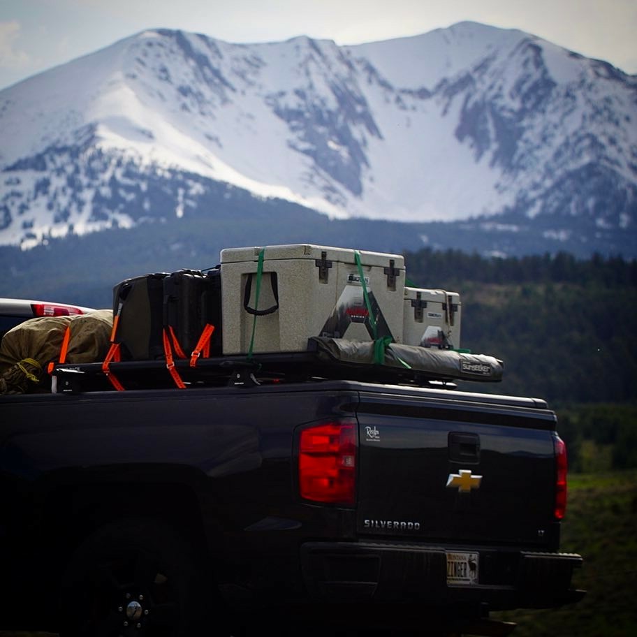 Lifestyle photo of Alpha Pro Series Coolers in the back of a truck