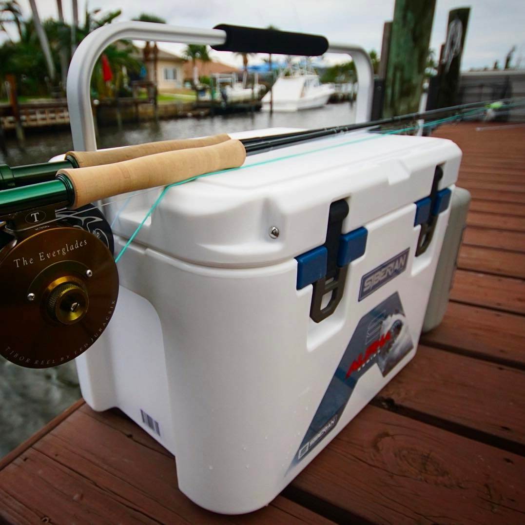 Alpha Pro Series 22 quart white cooler with a fishing rod sitting on a dock