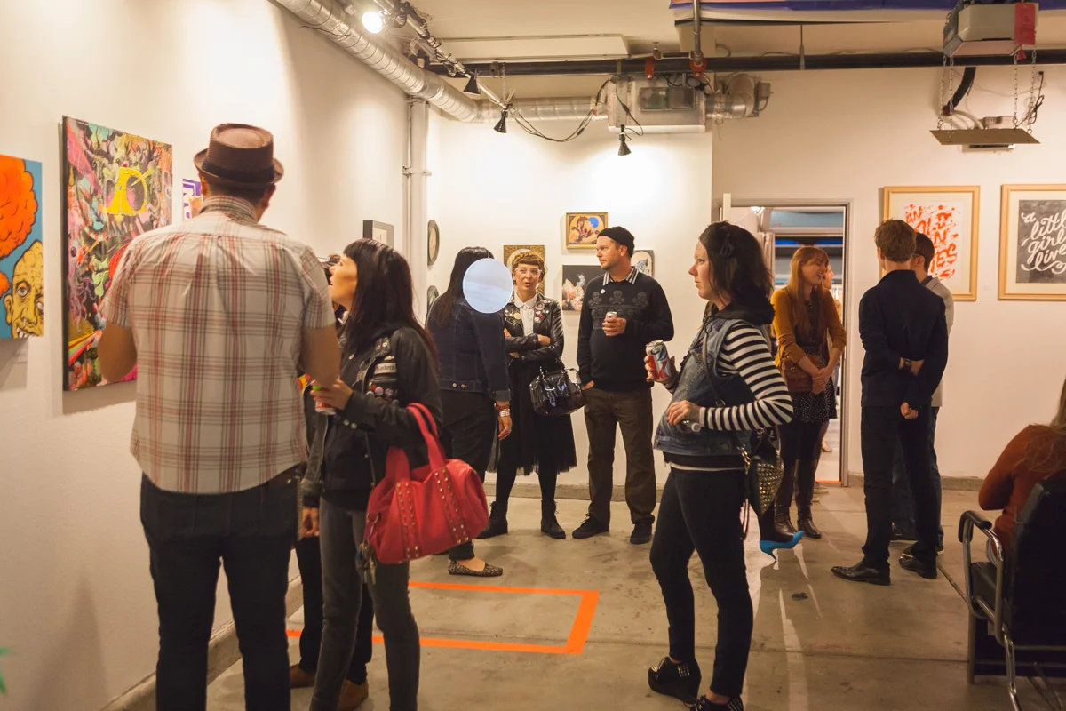 Some visitors in the back gallery at Newton's Third opening reception. 