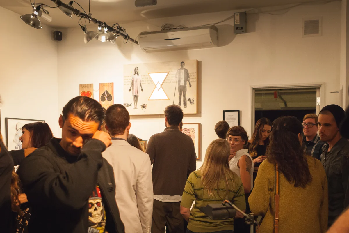 Visitors in the front gallery at F+ for Newton's Third opening night.