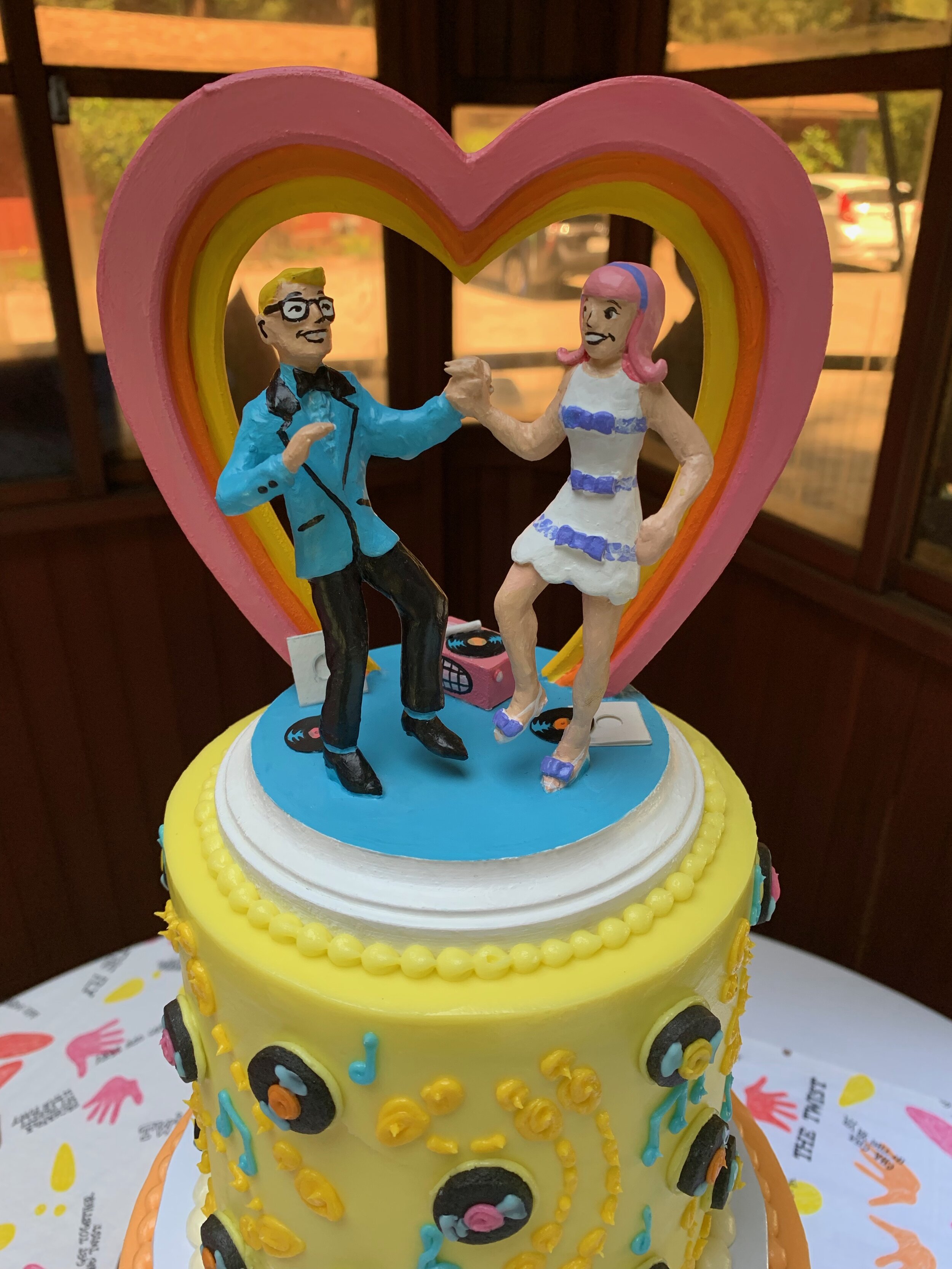April and Fred’s vintage-kitsch wedding invites featured an adorable cartoon of them dancing to 45s. I adapted that illustration for their cake topper and designed their cake to match!