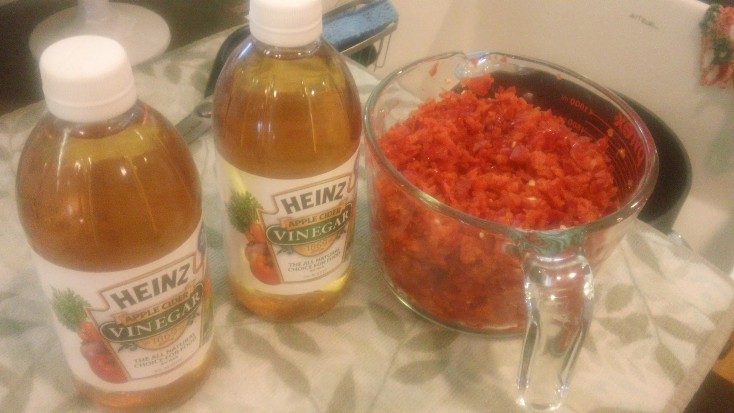 Mixing ingredients to make red pepper jelly. Once canned, you dump it on a cube of cream cheese and spread it on crackers. It makes for a sweet, spicy mix slathered on a cracker.