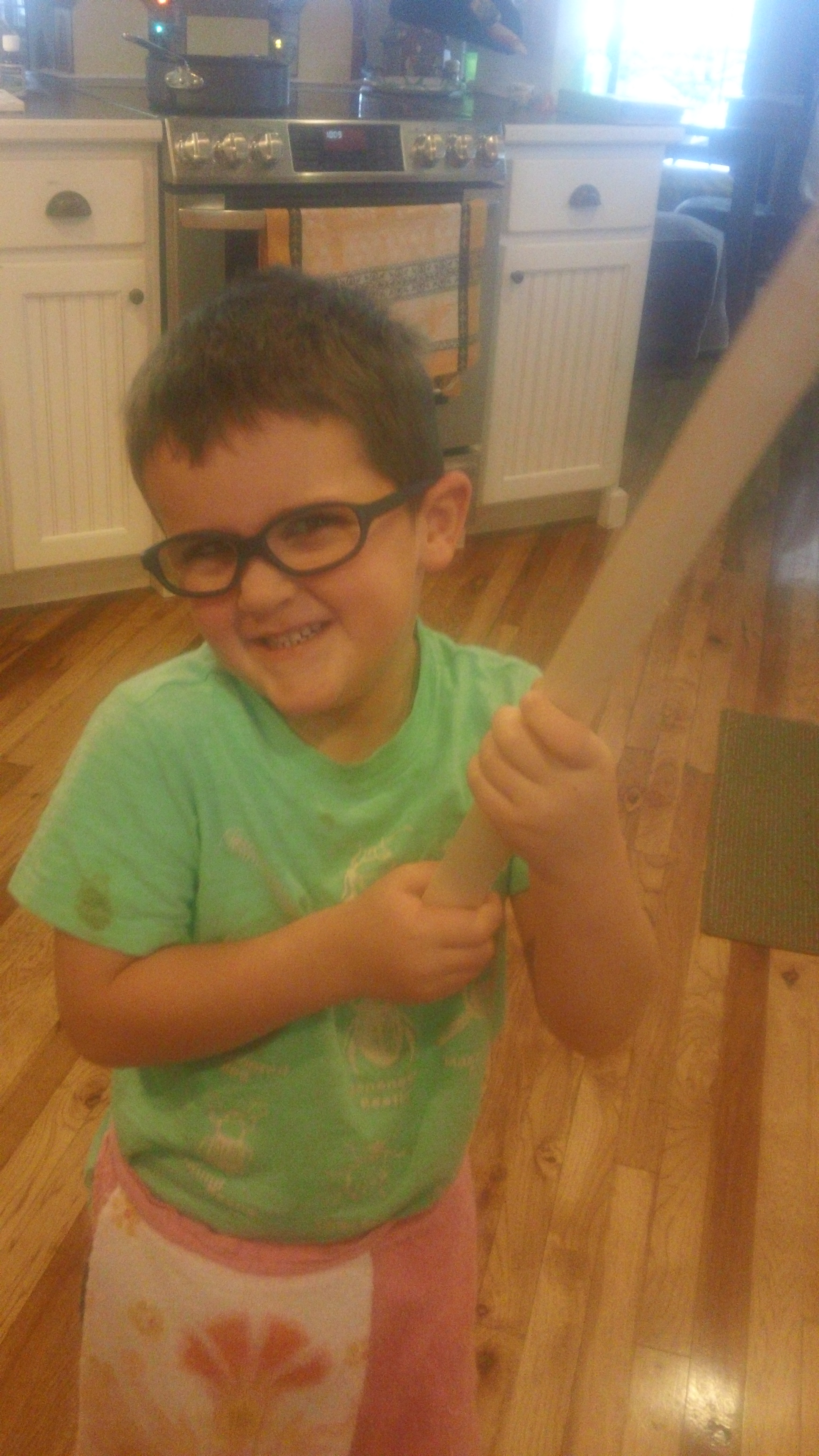 Emmett with his lefse stick ready to flip the lefse. 