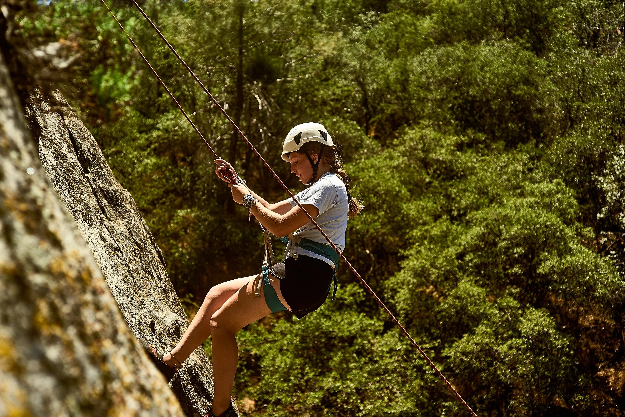 Camper on a rock face at Jameson Ranch Camp — youth rock climbing and belaying program, Southern Sierra Nevada, California overnight camp