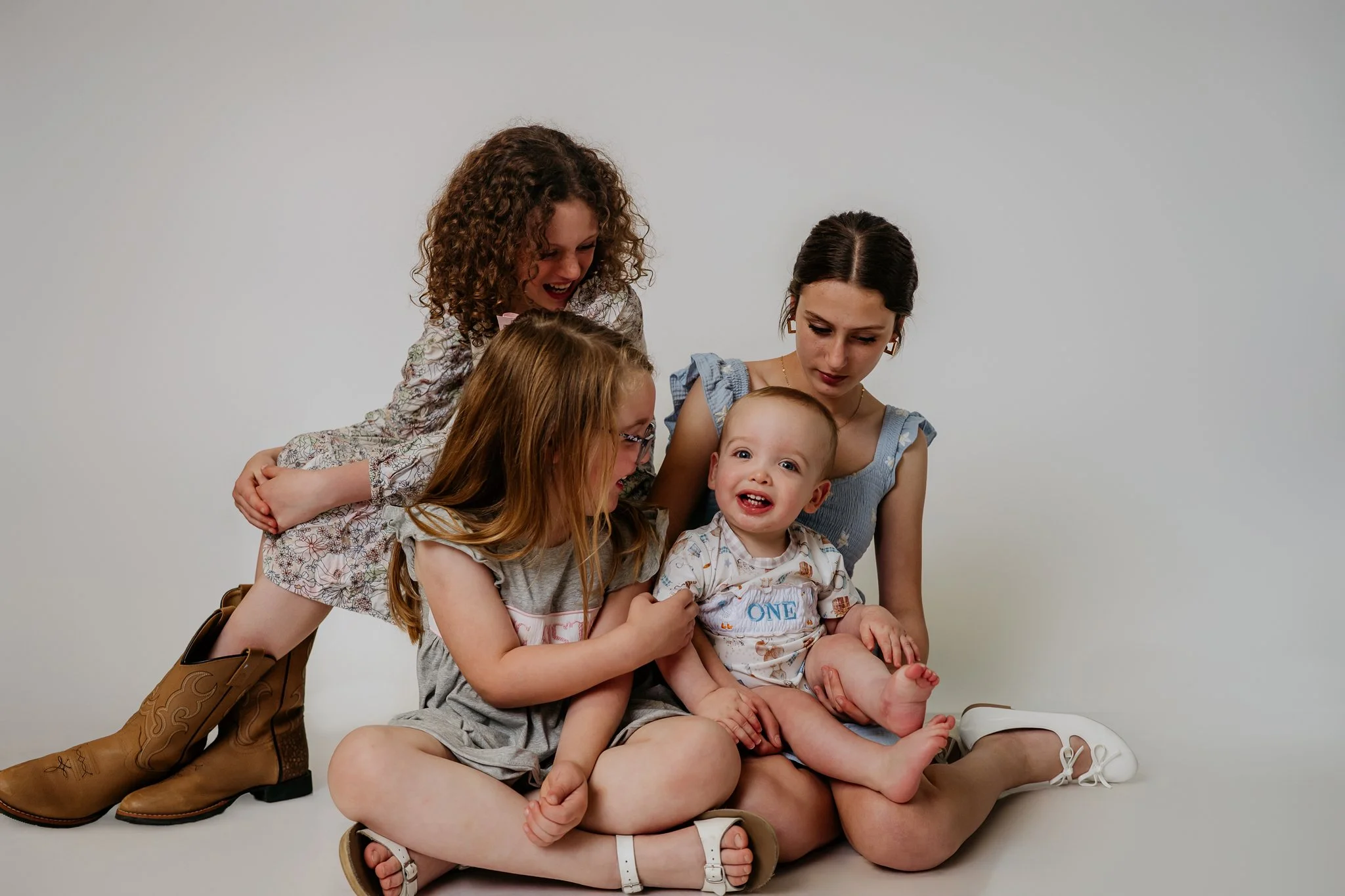 I wonder if this little dude realizes how loved he is? Could you imagine being surrounded by so many wonderful gals, plus a mama who loves you more than the world could explain! #milestonesession #childhoodphotography #oneyearold