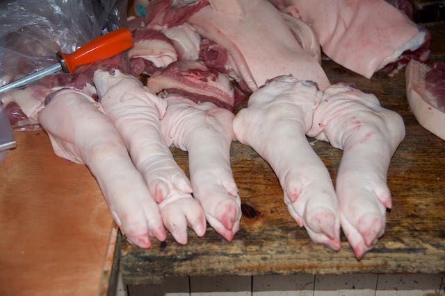 Pigs trotters in butchers stall, Market, Leshan, China, 15 Jun 2015.jpg