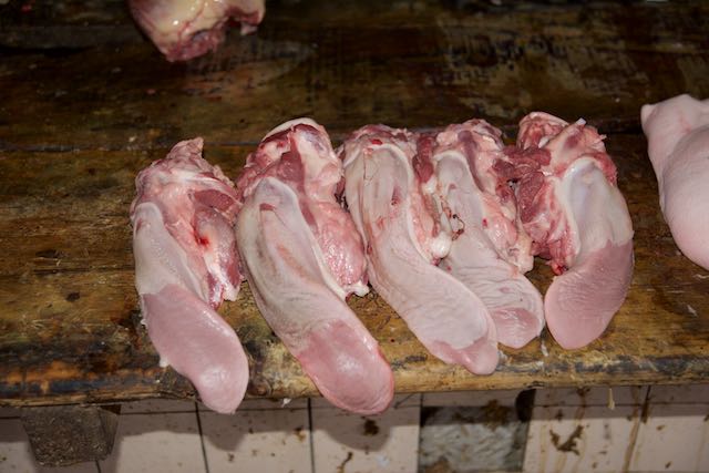 Tongues in butcher stall, Market, Leshan, China, 15 Jun 2015.jpg
