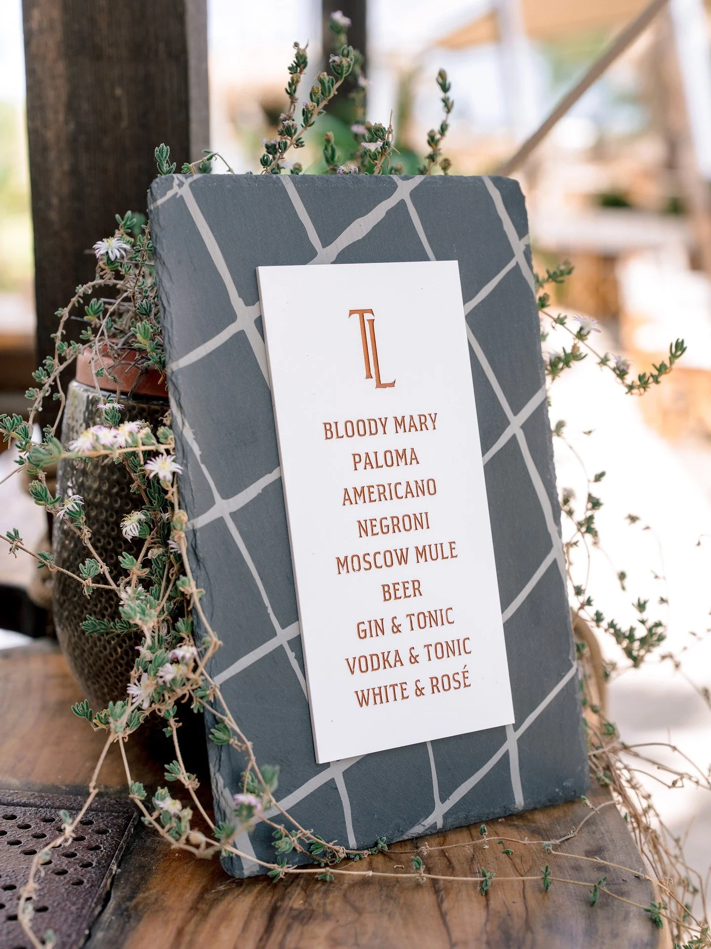 BRUNCH &amp; BEACHSIDE AFTERGLOW // Linen folios with the couple&rsquo;s monogram and slate signs layered with acrylic and paint-filled to match the plates set the scene in warm, earthy tones. Guests took home embroidered caps, gift totes, and custom