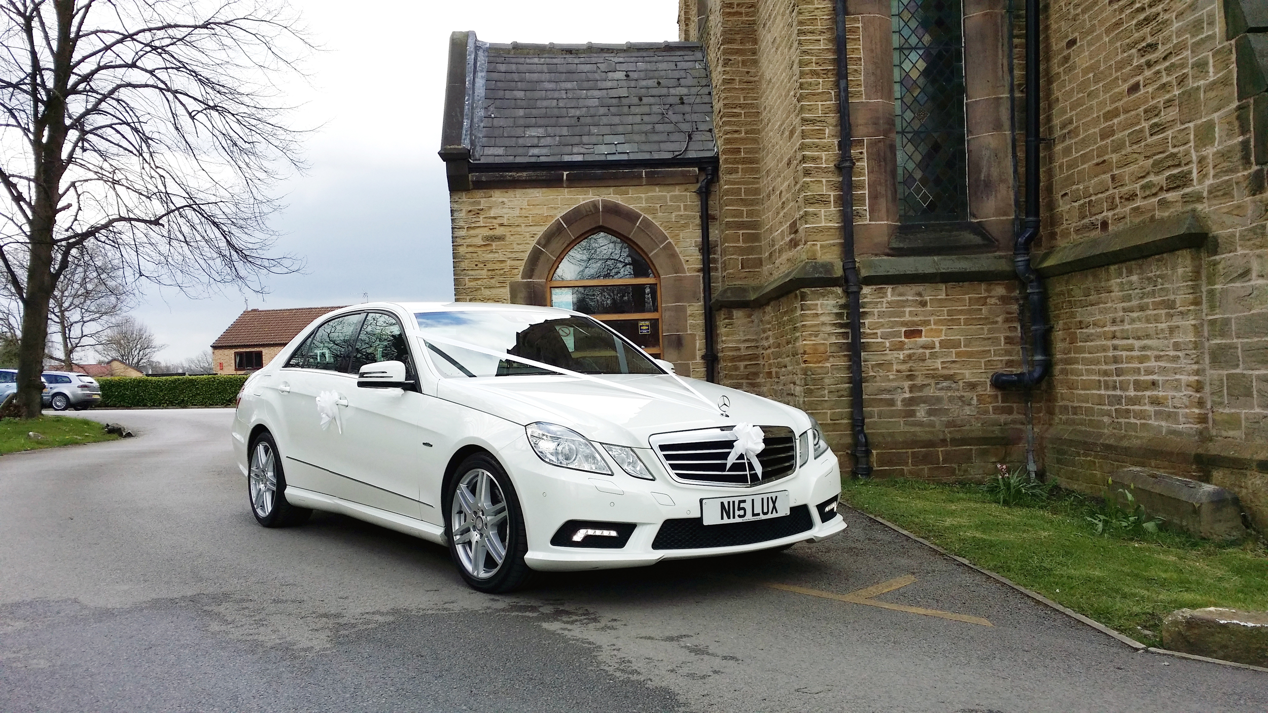 White wedding car at Holy Trinity Church, Thorpe Hesley