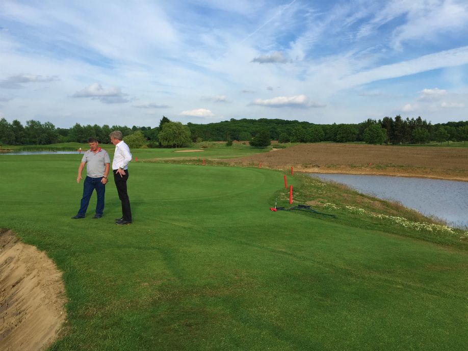  Course Owner Jamie Saitch and Turfdry MD Melvyn Taylor discuss construction of a new bunker, next to newly constructed pond. 