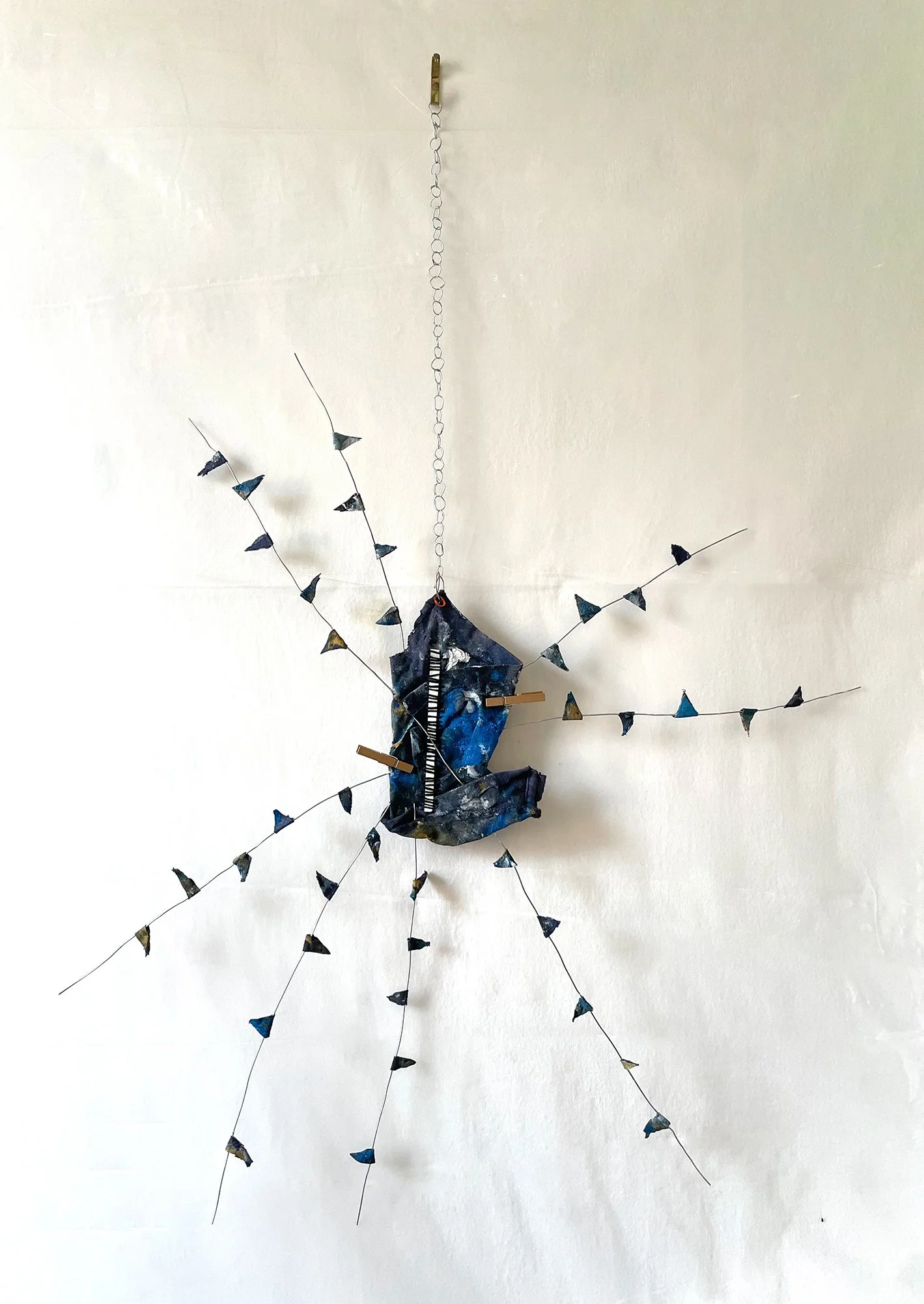 Handchime (2022)  I  Dried oil paint on rag, metal wires, wood clips  I  19x26 in. (variable)