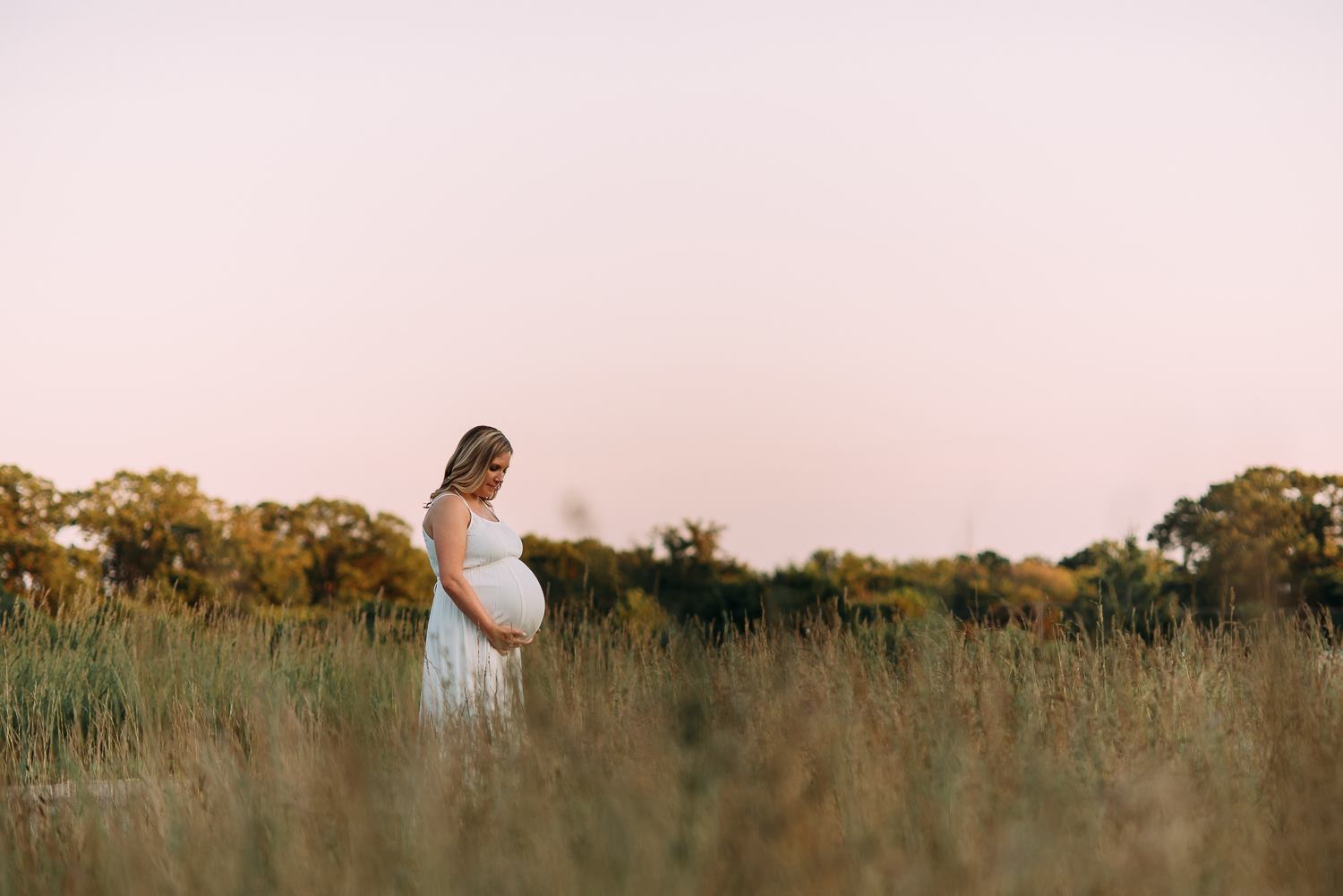 maternity photography pregnant woman in long white dress in field at sunset Baltimore Photographer