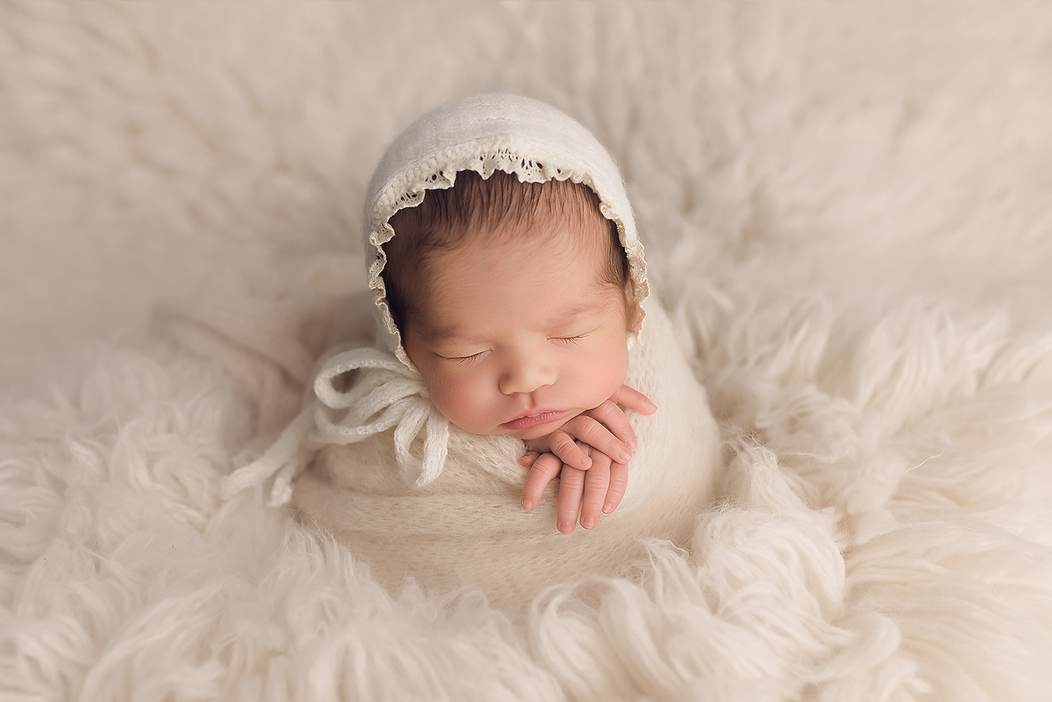 Baltimore Maryland Newborn Photographer Jessica Fenfert baby girl on cream flokati potato sack