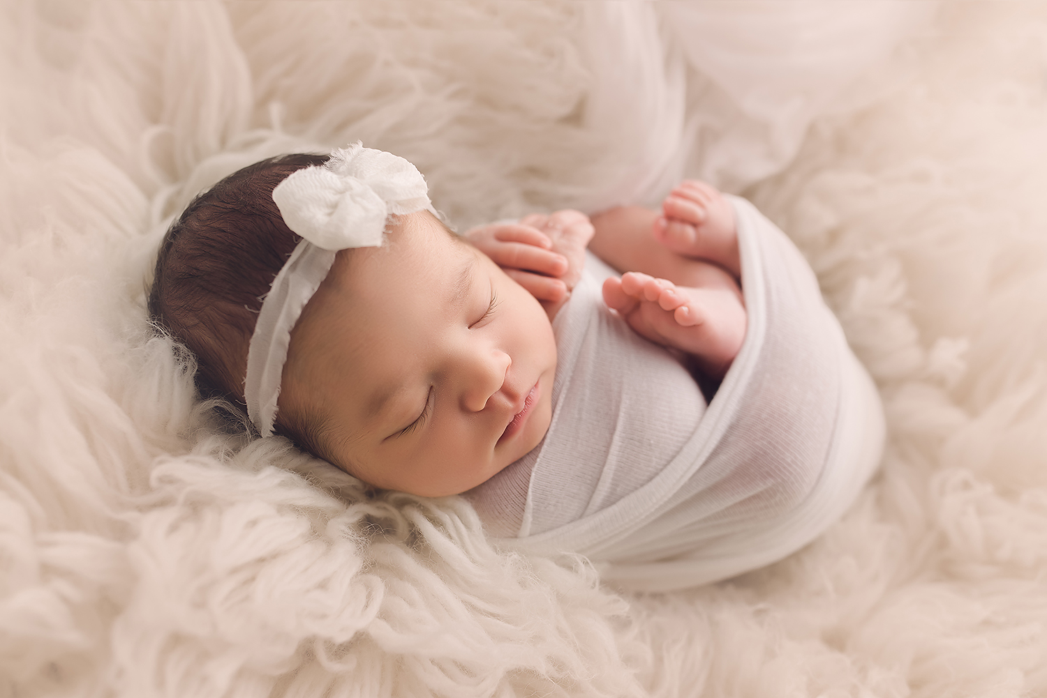 Baltimore Maryland Newborn Photographer Jessica Fenfert baby girl on cream flokati wrapped