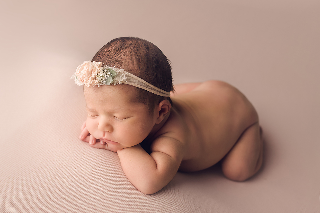 Baltimore Maryland Newborn Photographer Jessica Fenfert baby girl on pink head on hands profile