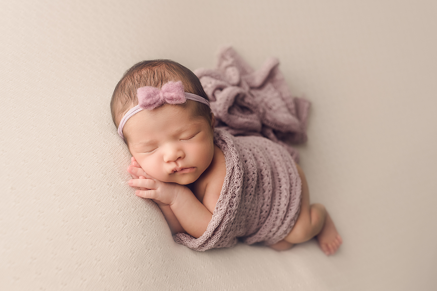 Baltimore Maryland Newborn Photographer Jessica Fenfert baby girl on cream purple wrap sidelying