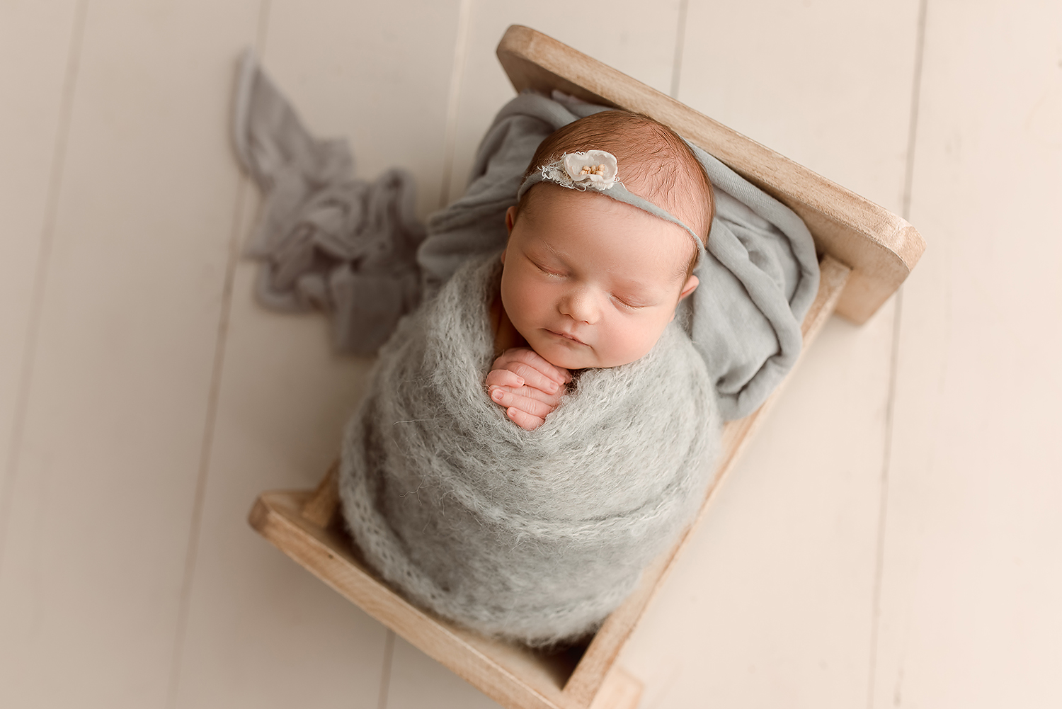 Baltimore Maryland Newborn Photographer Jessica Fenfert baby girl in gray in bed