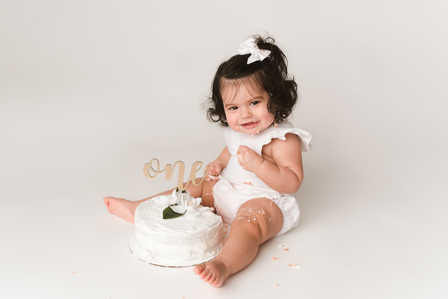 Baltimore Maryland Newborn Baby photography baby girl cake smash on white background Jessica Fenfert