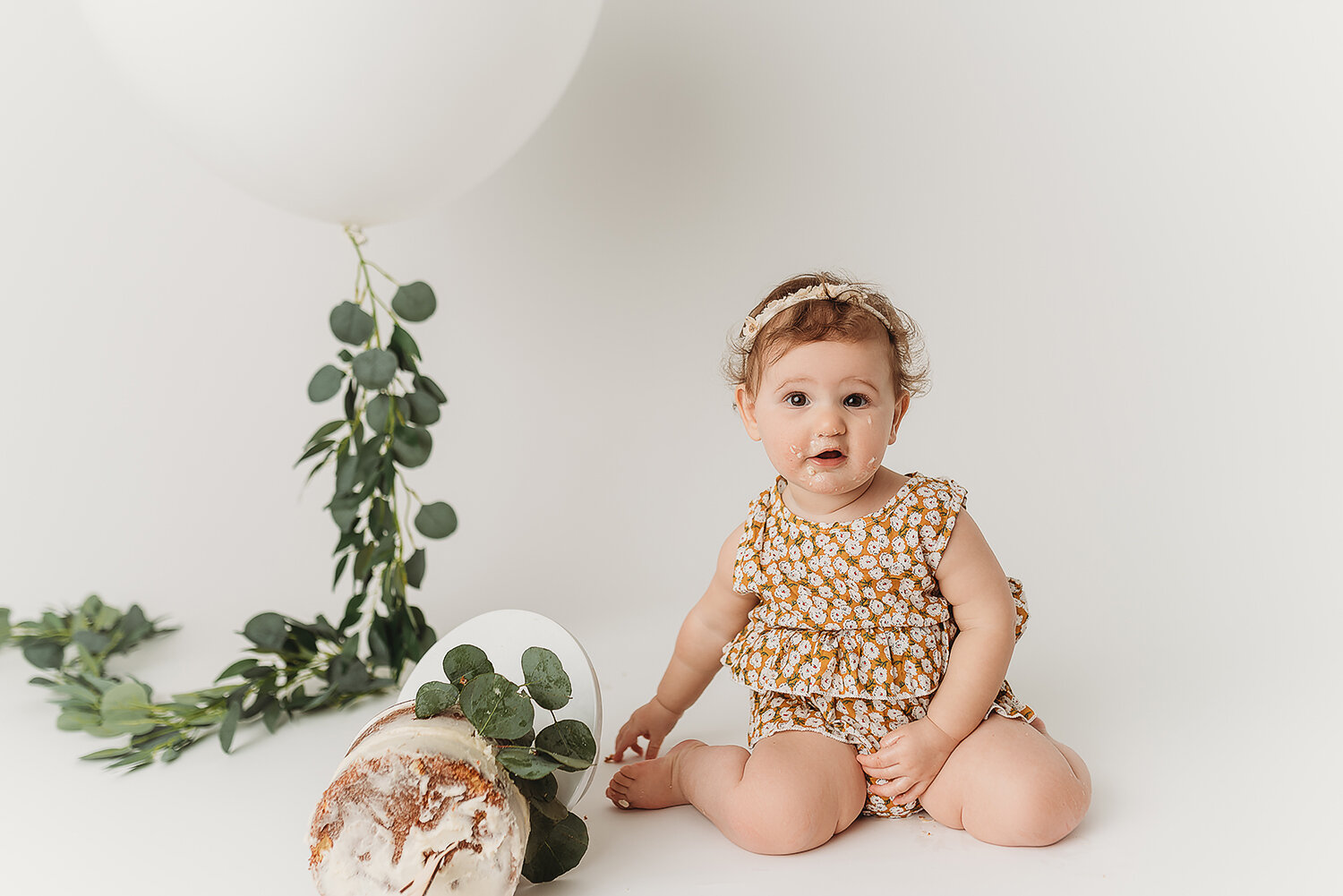 Baltimore Maryland Newborn Baby photography baby girl cake smash on white background Jessica Fenfert