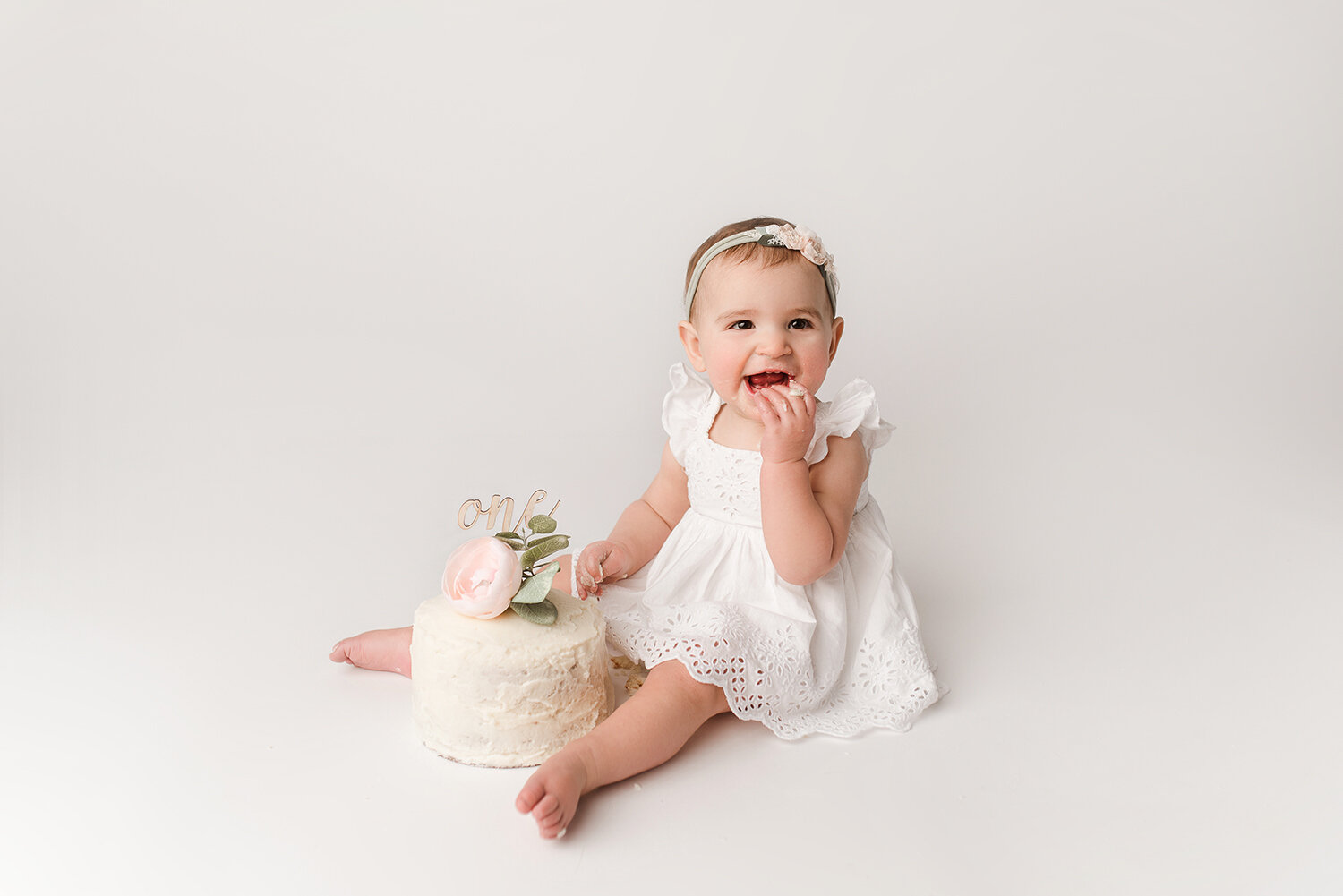 Baltimore Maryland Newborn Baby photography baby girl cake smash on white background Jessica Fenfert