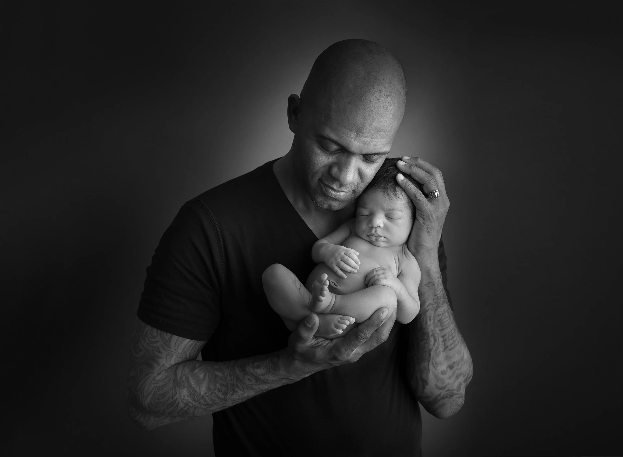 Portrait of a father and newborn baby