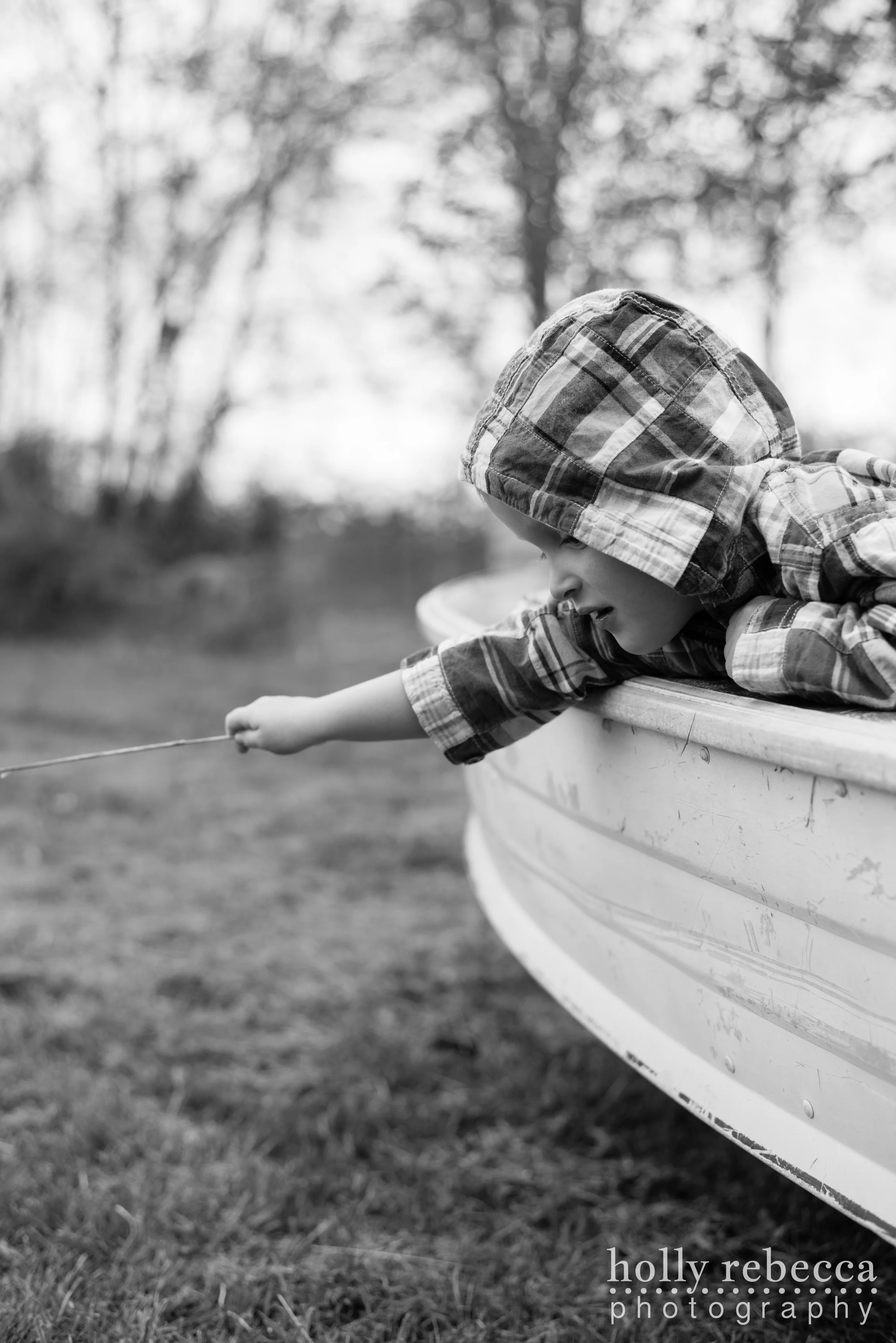 Boy leaning over the side of a boat