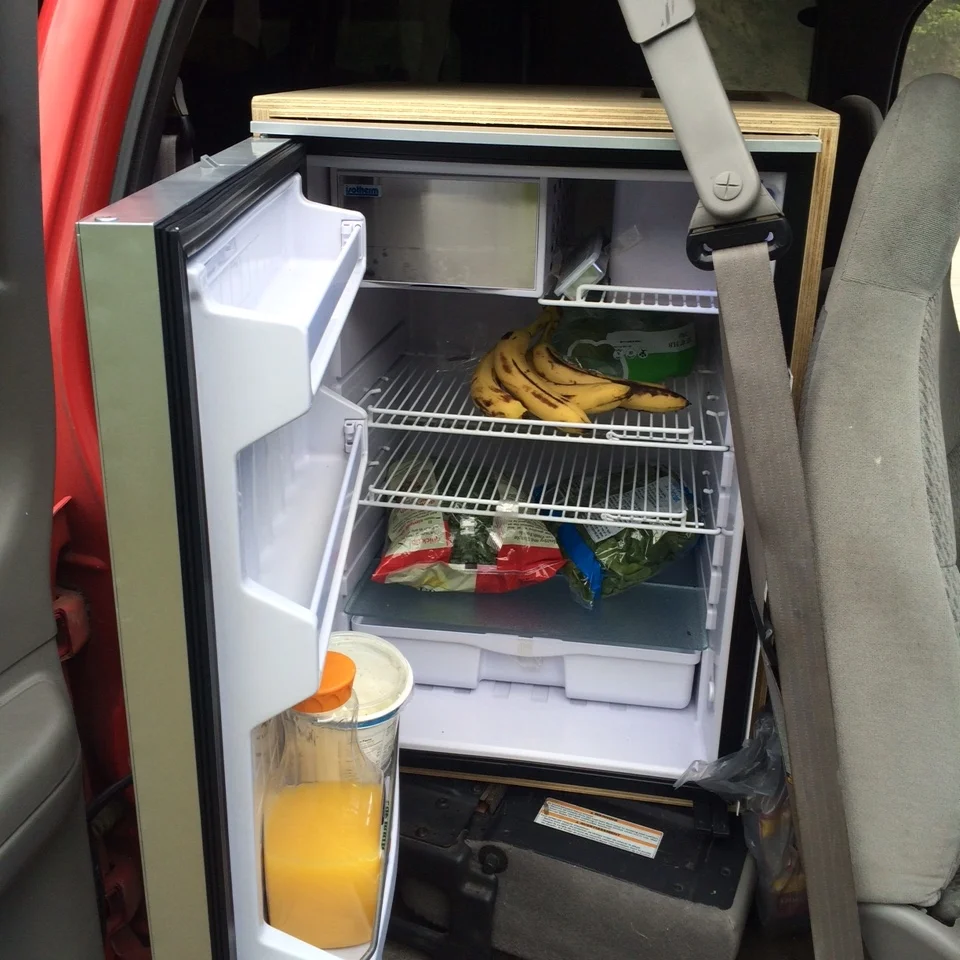I don't ever have to deal with buying ice or draining a cooler. I have a full-fledged mini fridge behind the front seat. It even has a enclosed freezer.