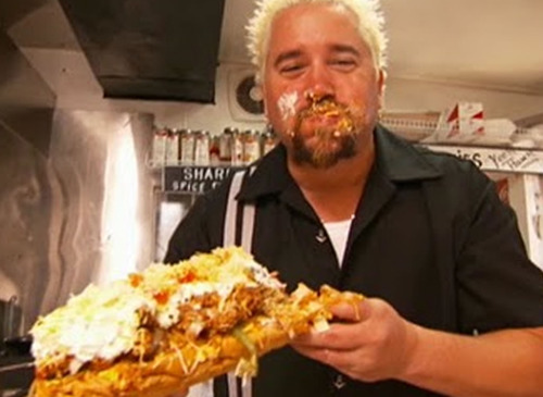 Guy Fieri holding his ticket to Flavortown