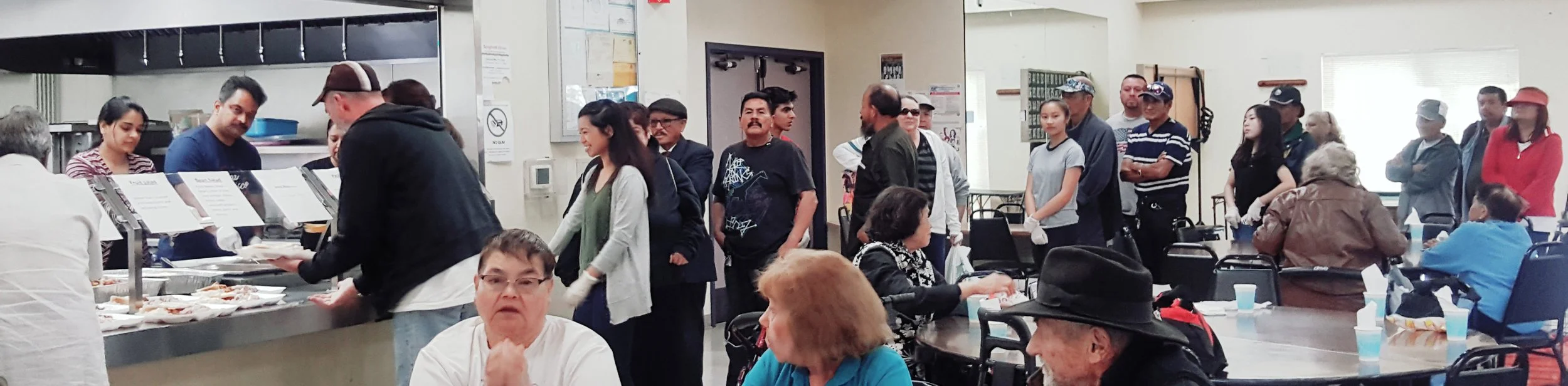 Photo courtesy Anne Santos with Loaves & Fishes People line up for a free meal at Loaves & Fishes meal service site at the Eastside Neighborhood Center on Alum Rock Avenue.