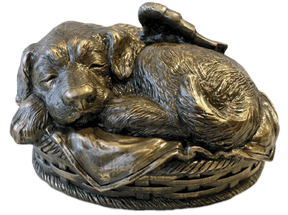 Resin sculpture of dog sleeping in basket