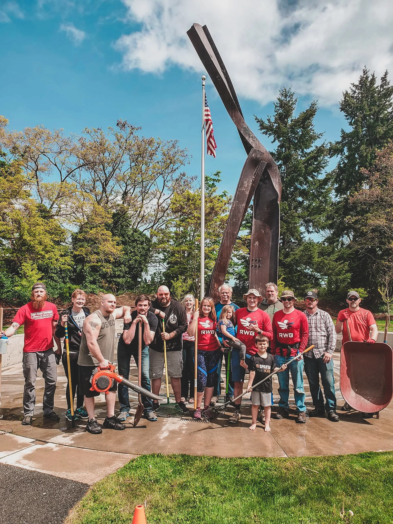 Here we stand next to a couple of the volunteers from the Bremerton VFW Post, some community members, and members of Team RWB Kitsap. It was great to see people from all different parts of our Kitsap community come to help clean up the Memorial site.