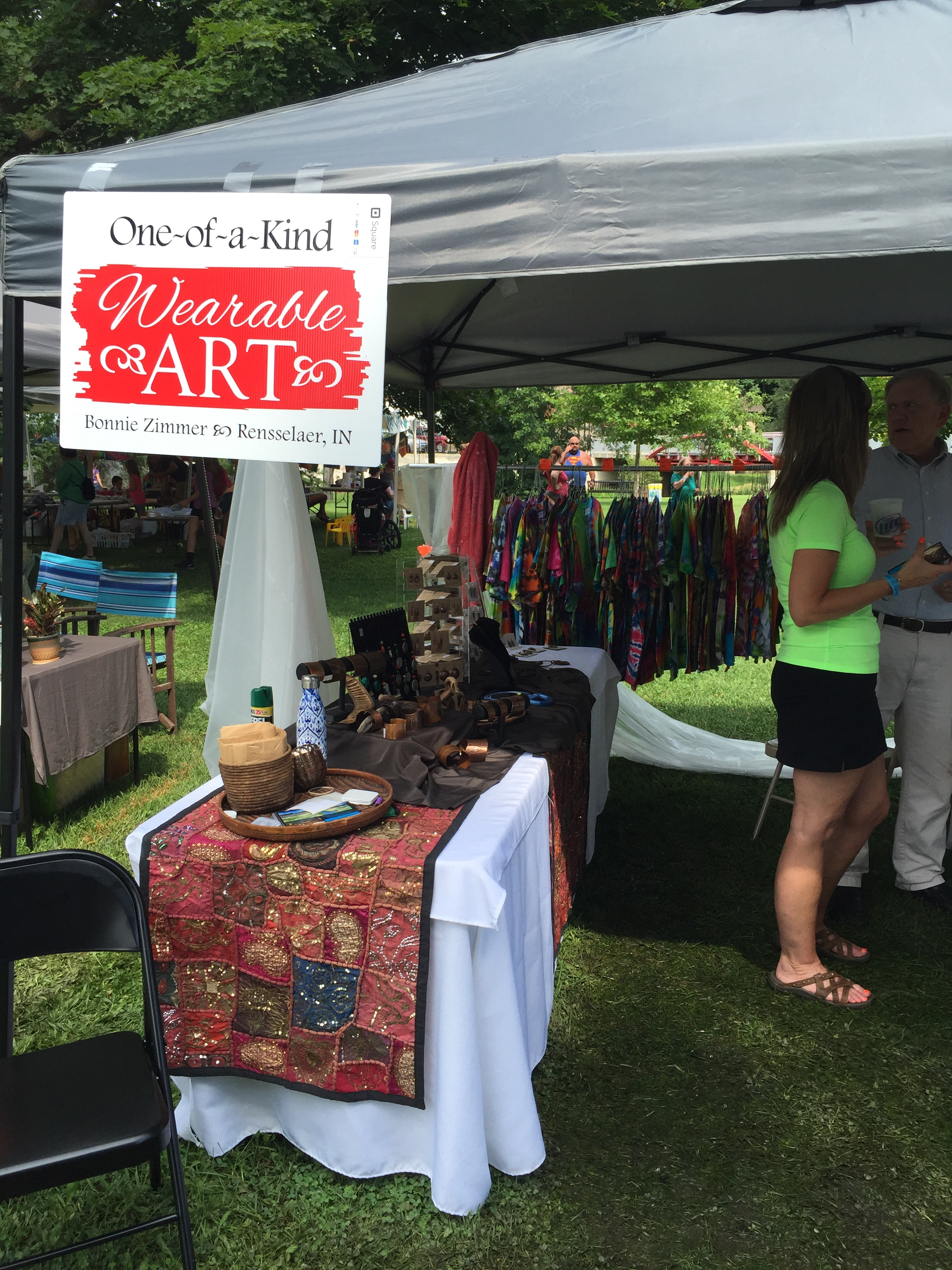 A snapshot of my booth, selling my "hobby art", copper, porcelain and mixed media jewelry and tie-dye shirts.