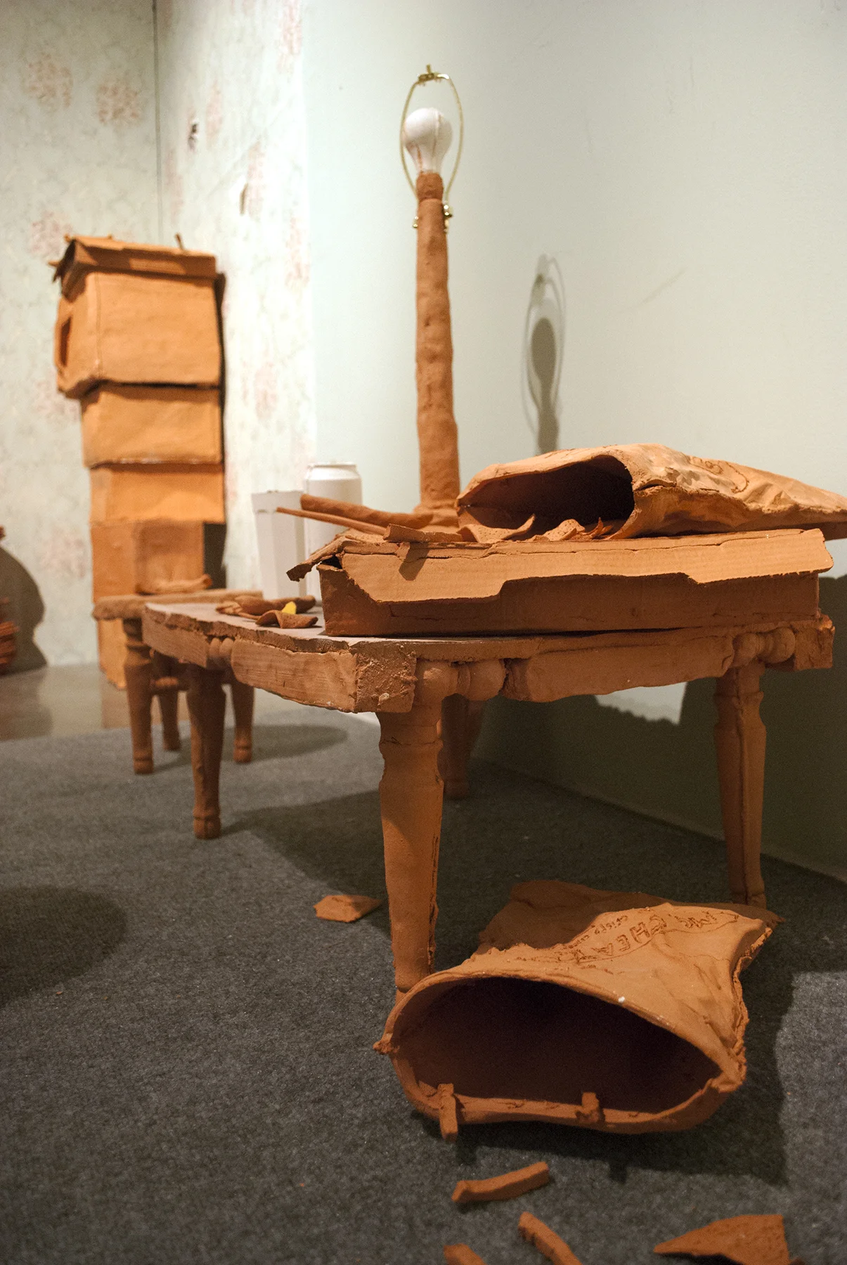 Terracotta, slip cast porcelain, found unfired cheese burger, carpet, metal, found cabinet, wallpaper, drywall, wood, latex Installation of life sized objects in 6’x12’x8’ room. 2018
