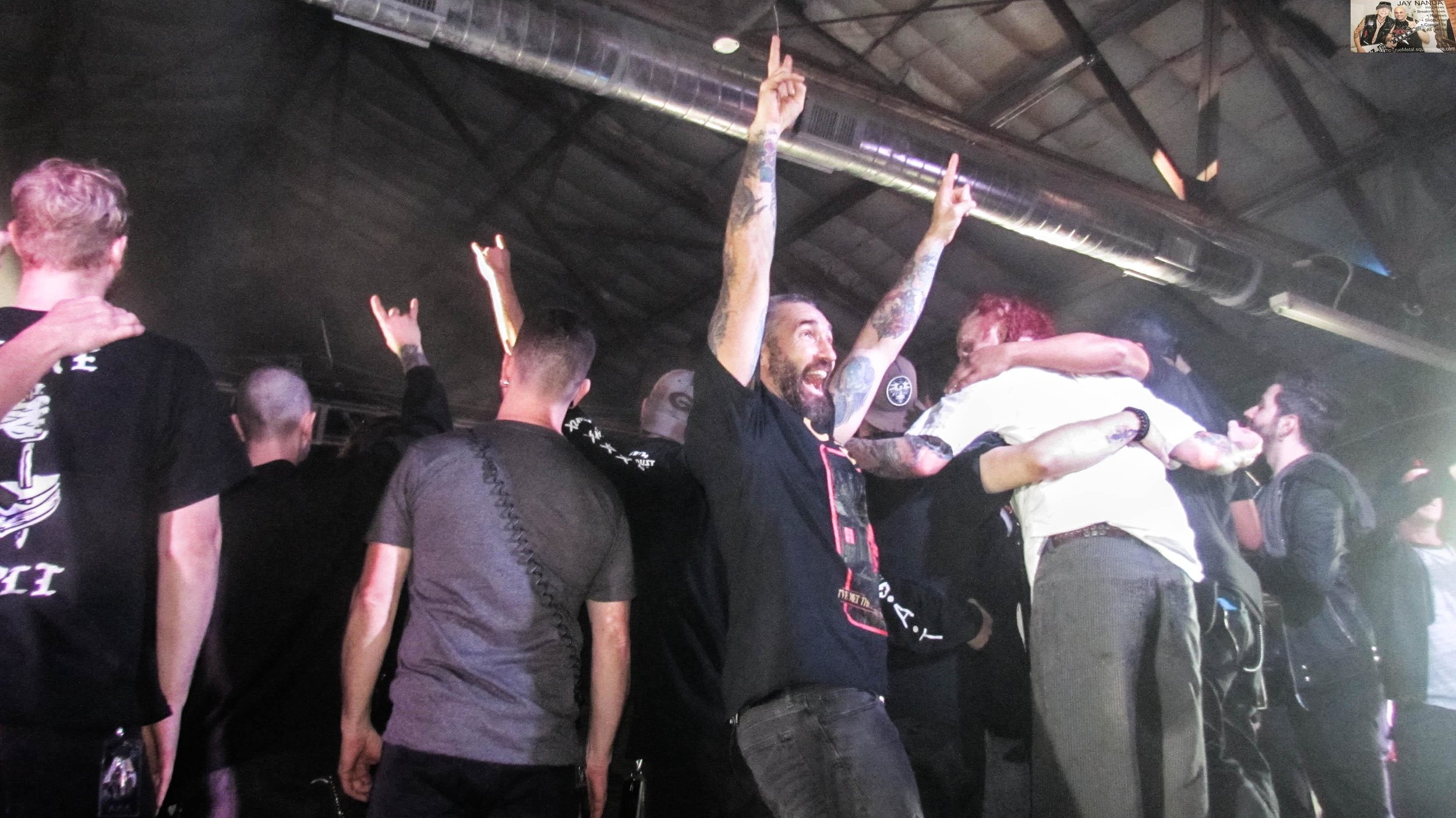 As the artists get lined up for a tour-ending picture, Sevendust guitarist Clint Lowery turns one last time toward the crowd.