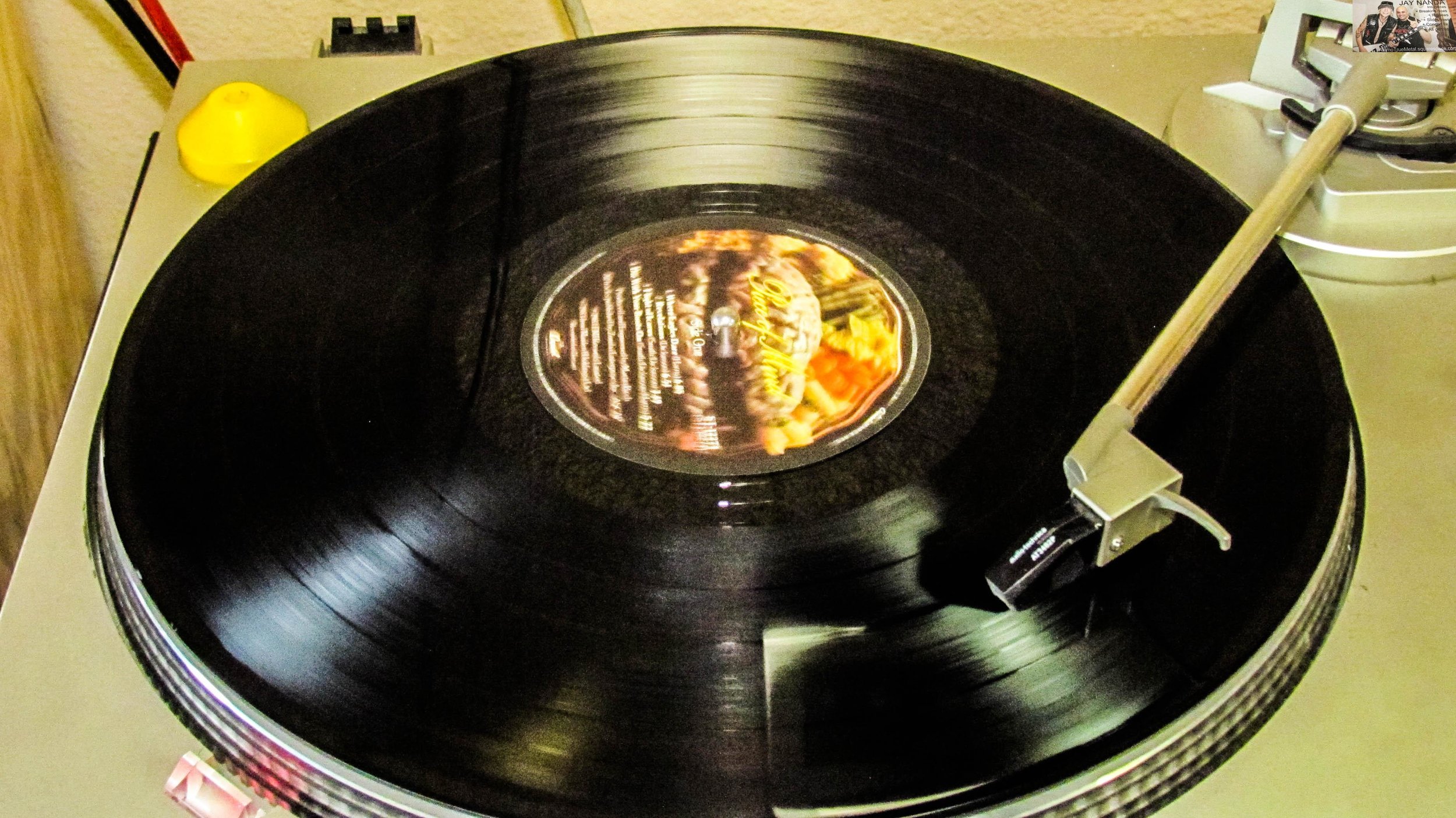 Iron Maiden’s “Piece of Mind” spins on vinyl between acts.