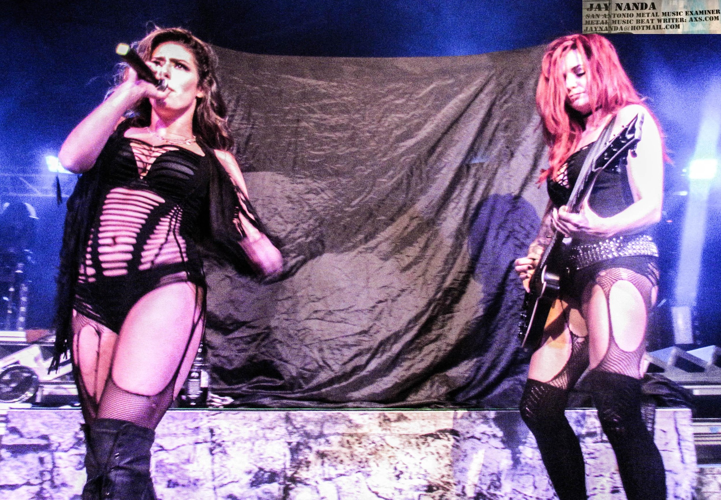 Taylor (right) plays the guitar while one of her dancers breaks out in song.  