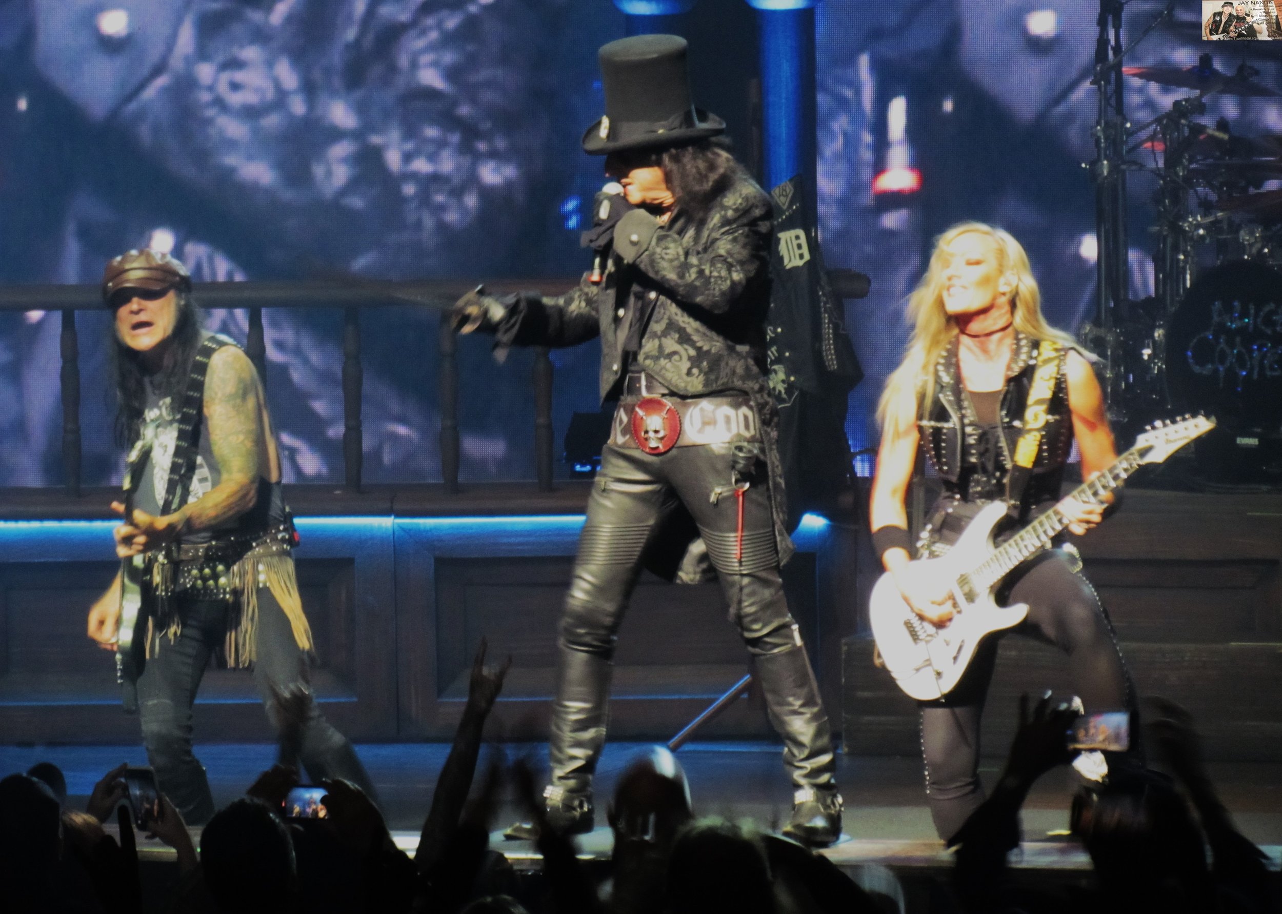  Cooper is flanked by guitarists Ryan Roxie (left) and “Hurricane” Nita Strauss. 