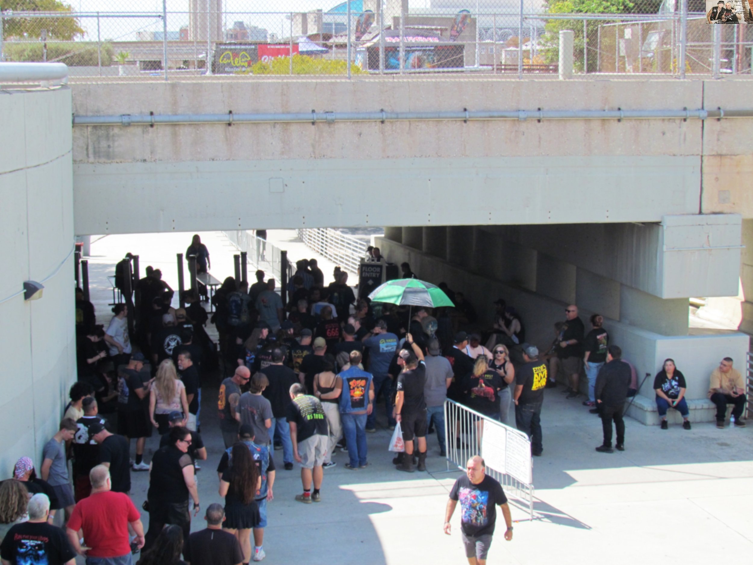  The crowd begins to form underneath the Alamodome as fans seek shade from the high-90 degree temperatures three hours before the show.  