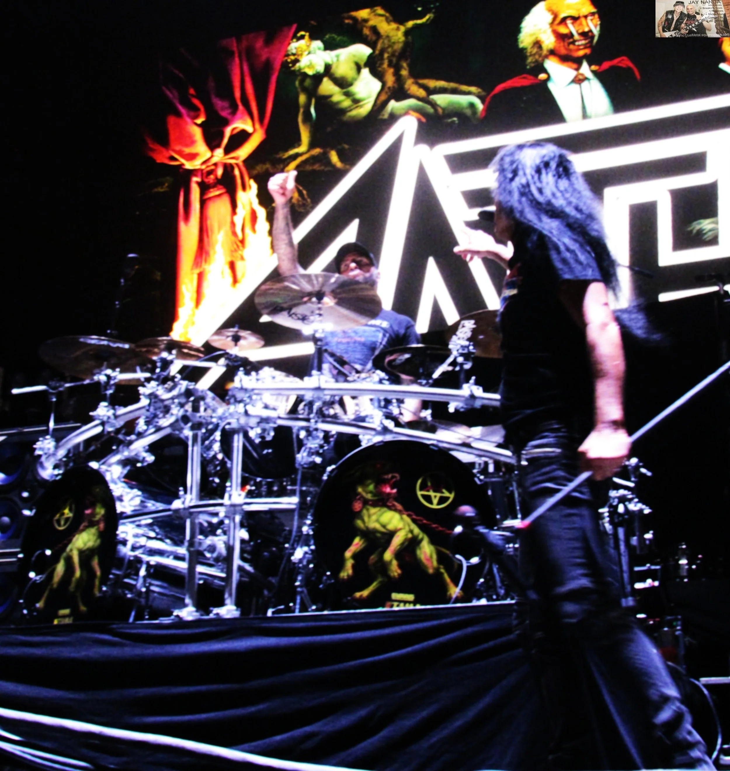  Belladonna acknowledges fill-in drummer and San Antonio resident Mike Heller after original drummer Charlie Benante woke up the morning of the show “puking his guts out” according to Ian.  