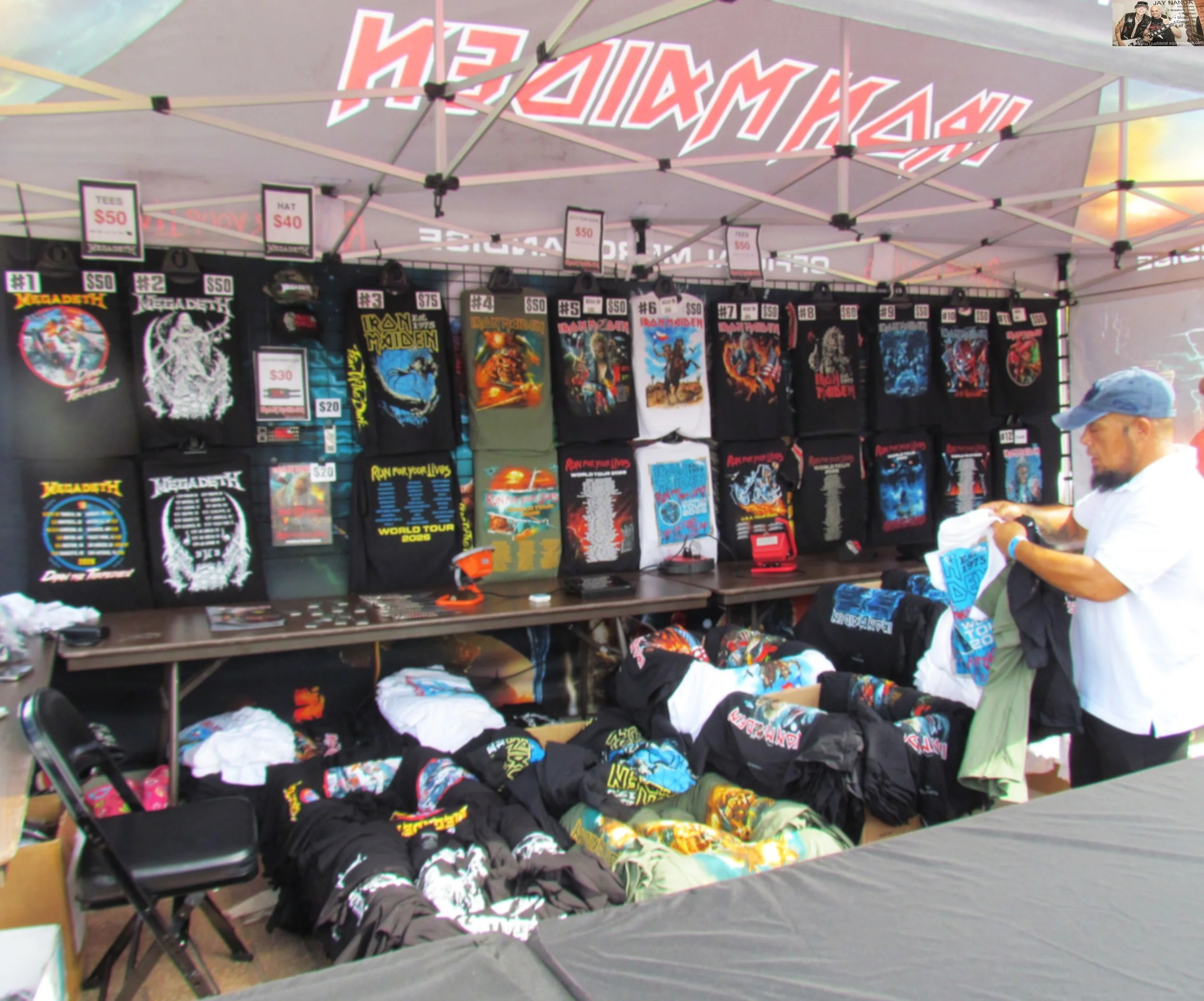  One of three T-shirt dominated merch booths stands on display outside prior to fans being allowed into the H-E-B Plaza and inside the Alamodome.  