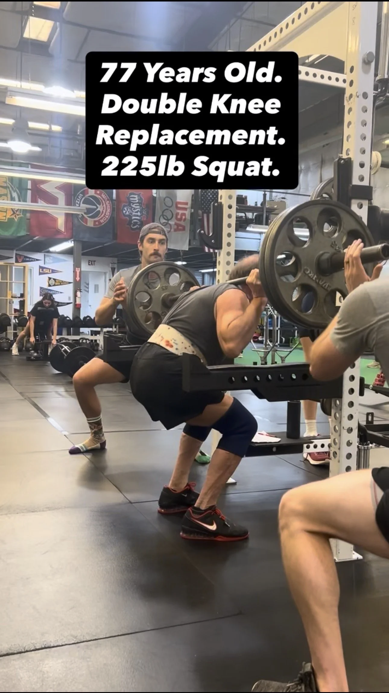 A 77-year-old SAPT client squatting 225 pounds with a coach spotting