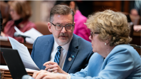 Senator Scott Dibble and Senator Ann Johnson Stewart discuss a bill during session
